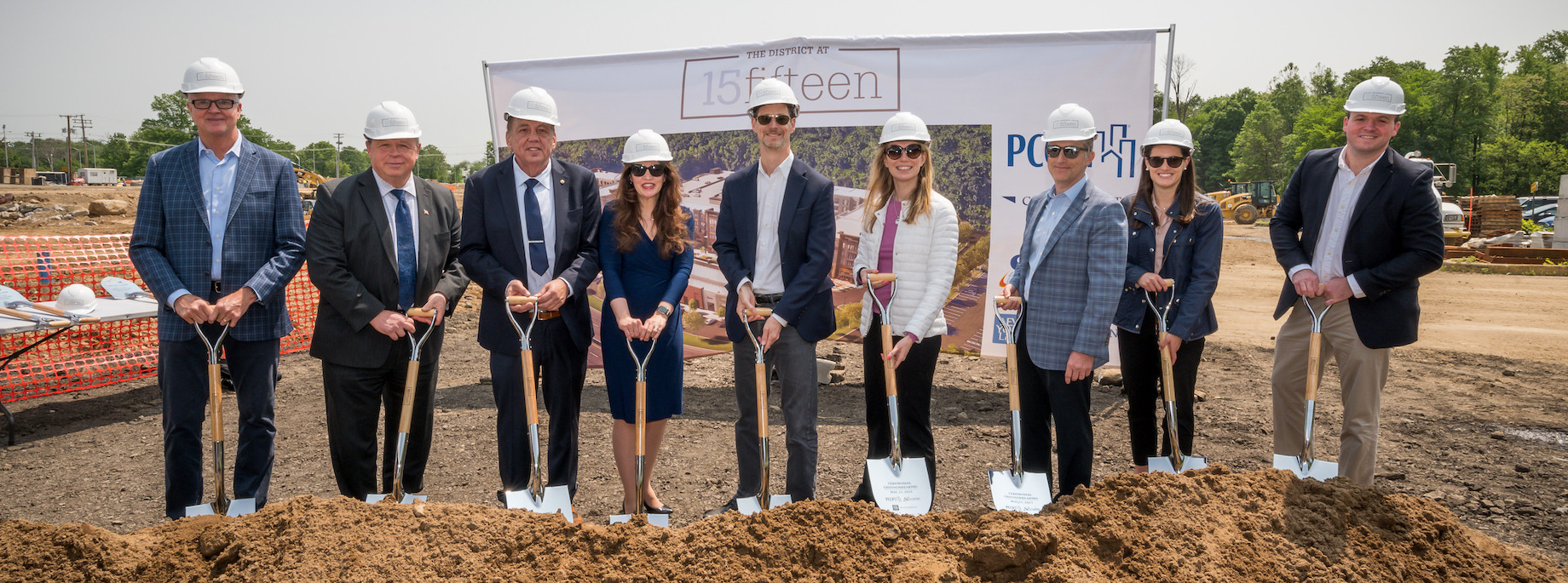 Executives break ground on The District at 15fifteen in Parsippany, New Jersey, which also is rendered at top.