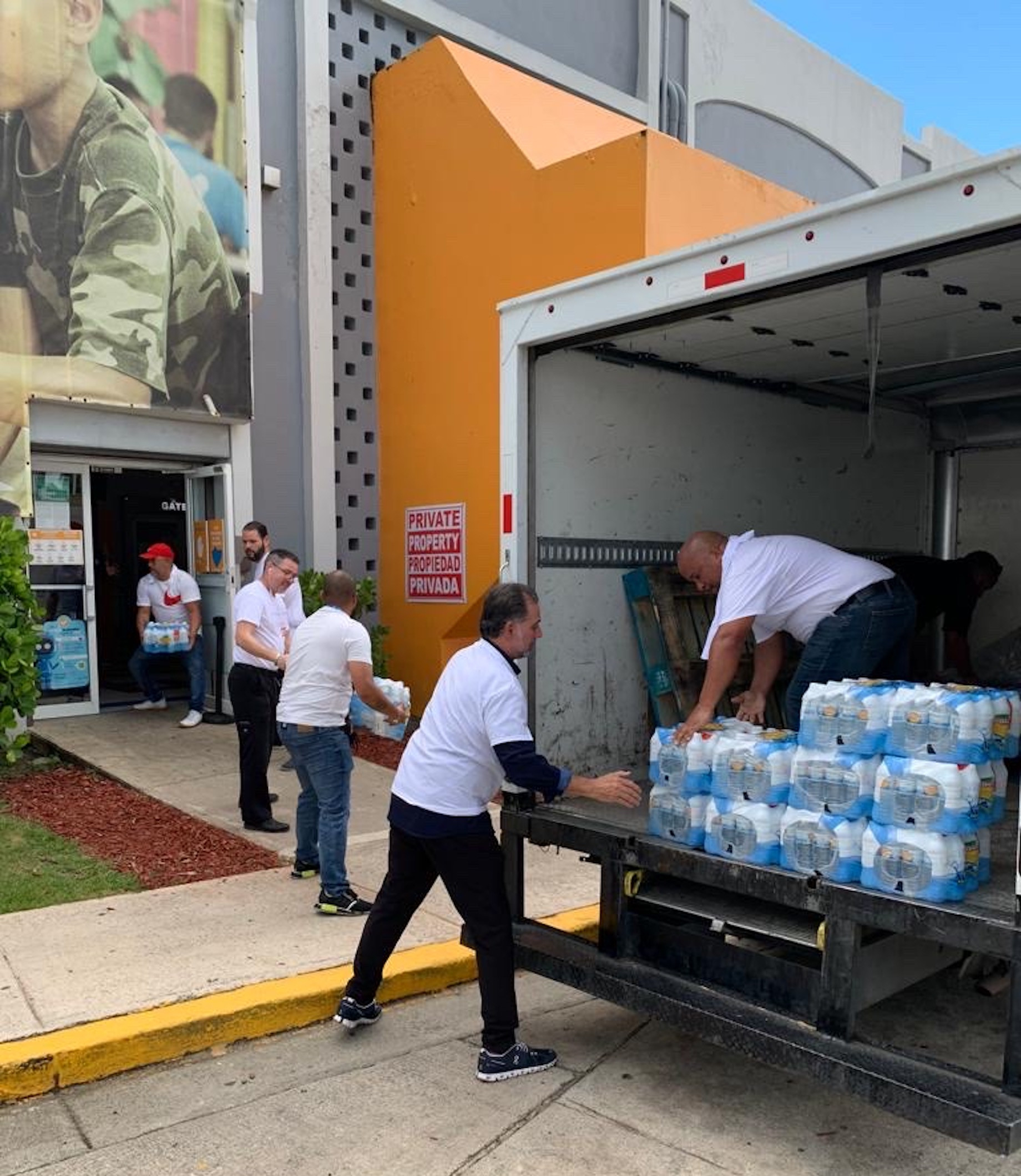 Above and at top: Mall of San Juan employees help the Puerto Rico community after Hurricane Fiona.